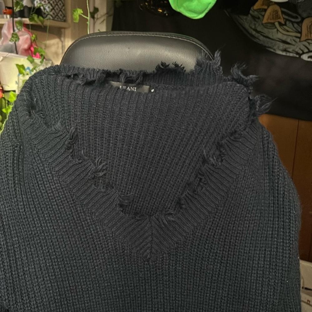 Small “ripped” looking navy blue sweater